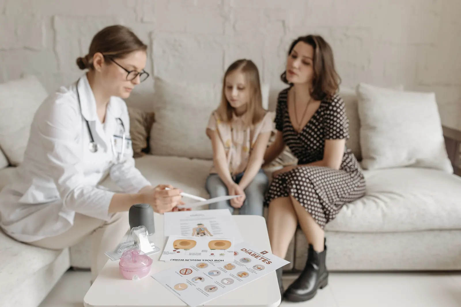A doctor talking with a mother and her daughter