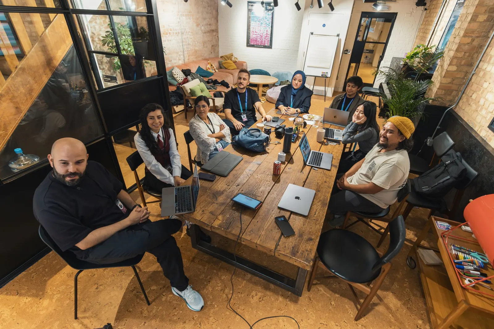 A group of colleagues meeting around a table in a modern office